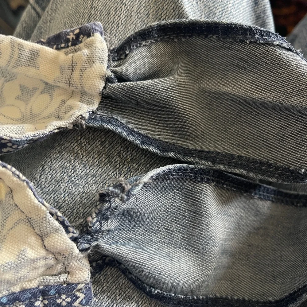 Vintage medium wash light weight ruffled denim apron with embroidered pocket.